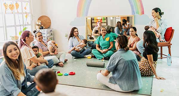 necac-about-us-early-childhood-professional-spotlight-2 Caregiver reading and learning with children