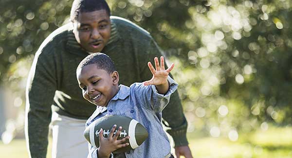 Father and son sharing a high five outdoors