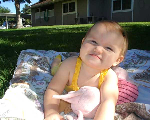 Young child enjoying a drink outdoors