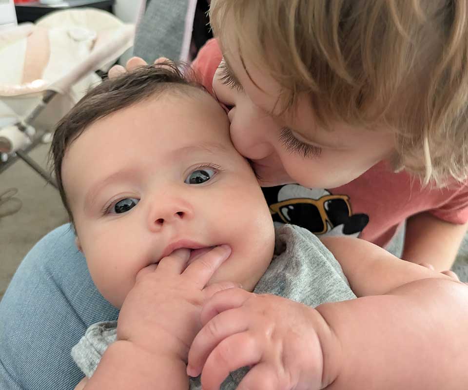 Parent kissing a young baby
