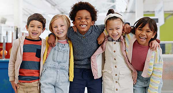 Diverse group of school-age children standing together