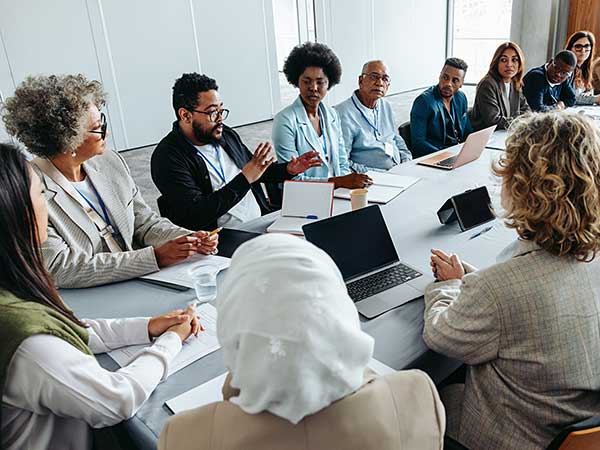 Professionals reviewing documents during a policy meeting