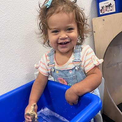 necac-hot-topics-legislative-hp Toddler playing on a blue indoor play structure