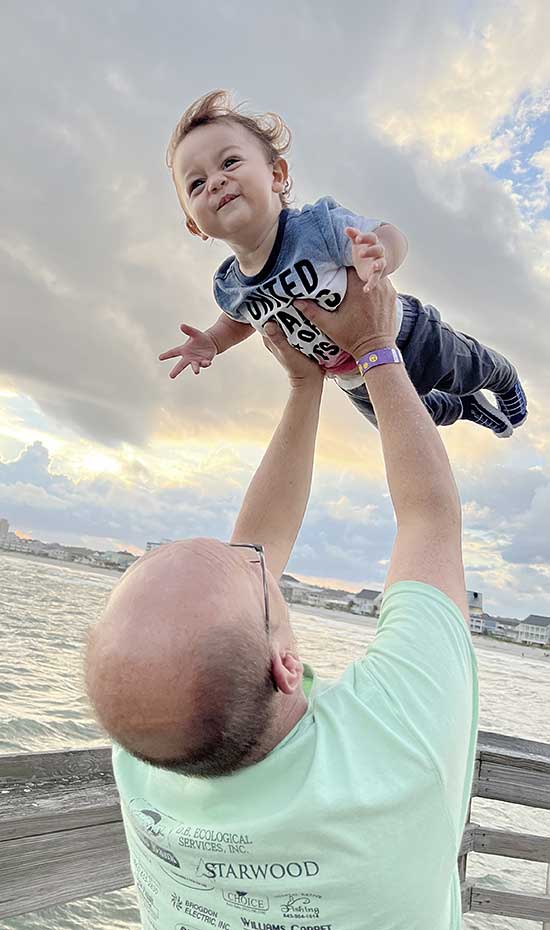 Nevada ECAC Reports and Documents Adopted Adult lifting a smiling child outdoors