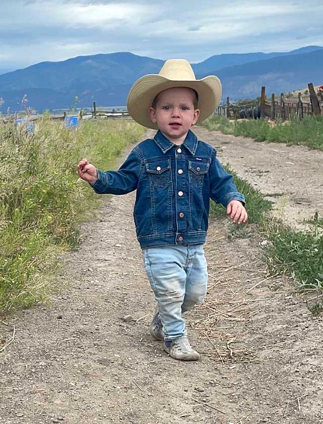 Nevada ECAC Reports and Documents Approved Young child in a cowboy hat standing in a mountain landscape
