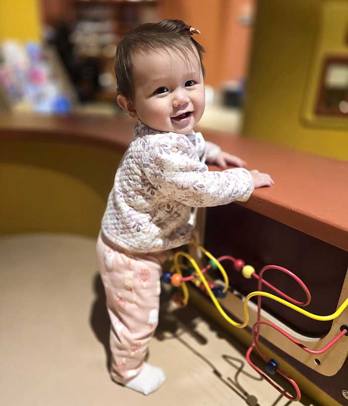 Toddler playing with a bead maze