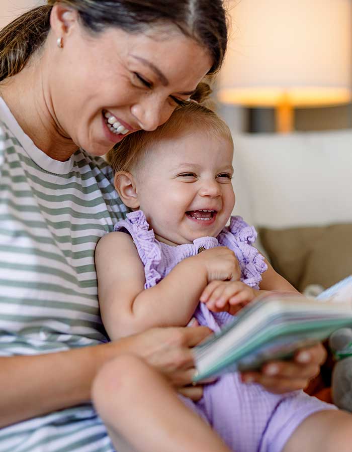 Nevada ECAC Subcommittees Data Documents Parent holding a baby while reading a book