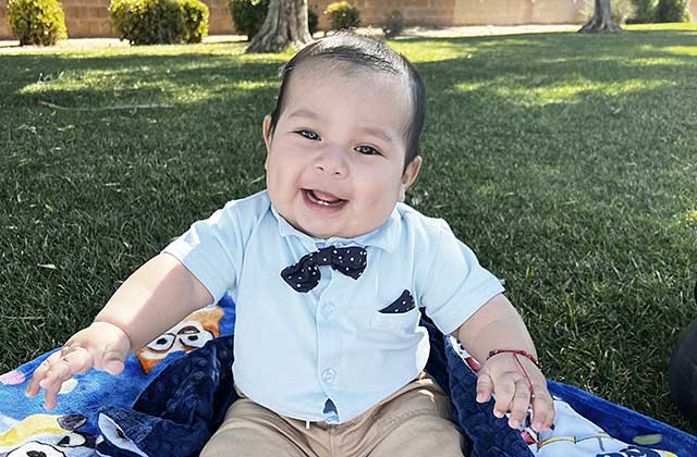 Young child dressed formally and seated at a table