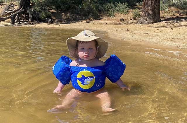 Nevada ECAC Subcommittees Meetings Calendar 1 Young child wading in water while wearing a flotation vest and sun hat