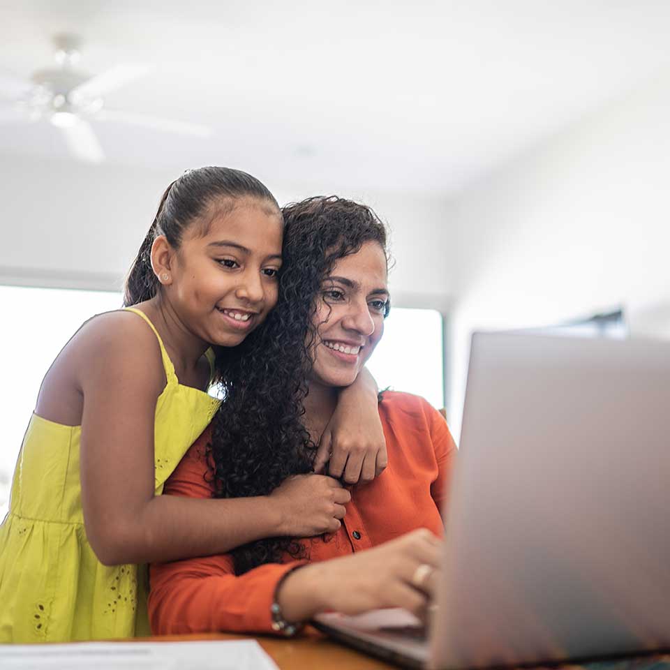 Two women reviewing information on a laptop