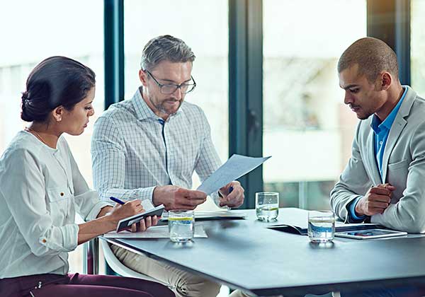 Adults collaborating around a meeting table