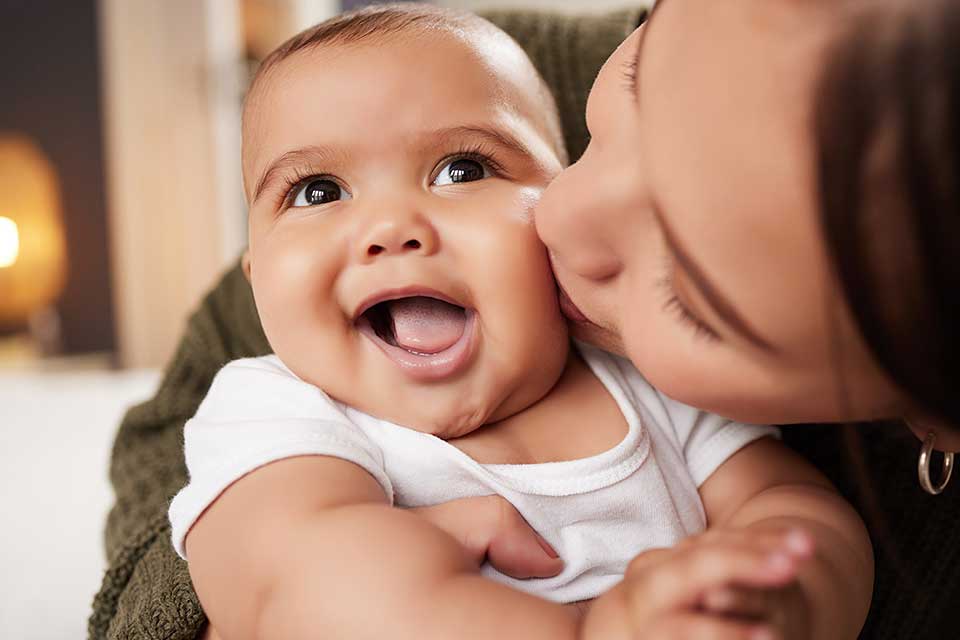 Nevada ECAC Subcommittees Welcome Parent kissing a happy baby